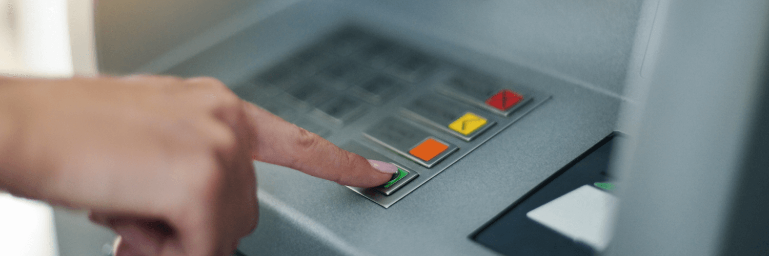 hand of user operating atm machine